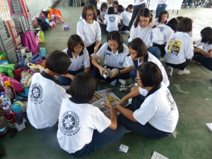 Members building airplane using recyclable items provided.